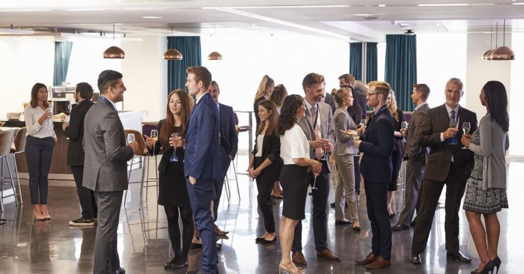 Product Launch Event Planning: Guests networking and interacting at a modern corporate product launch event.