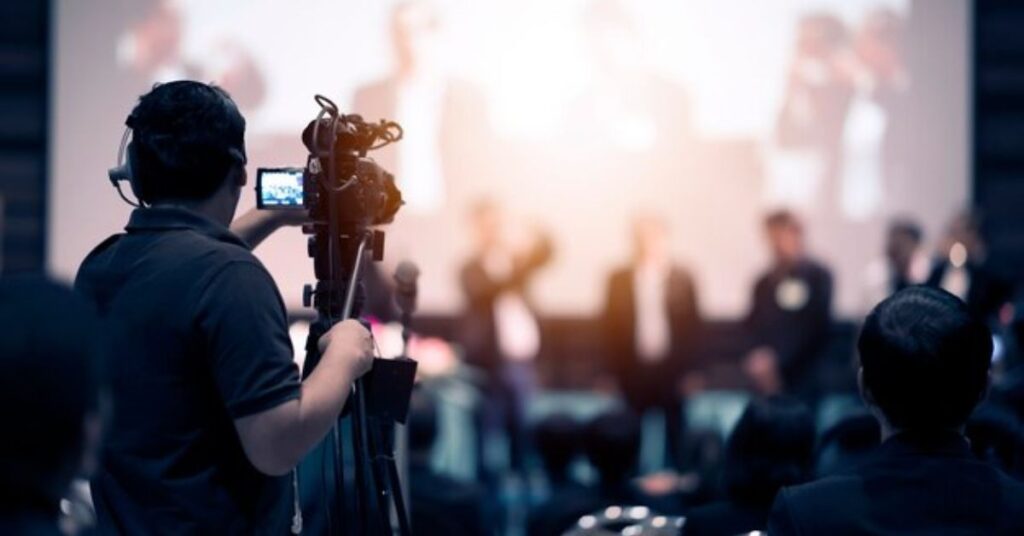 Professional photographer capturing candid moments during a corporate event. 